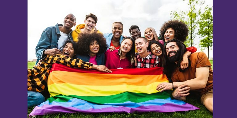 A diverse group of people with a pride flag
